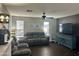 Comfortable living room featuring a sofa, seating area, wood floors, and lots of natural light at 491 E Jeanne Ln, San Tan Valley, AZ 85140
