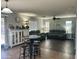 Spacious living room featuring a sofa, seating area, wood floors, and lots of natural light at 491 E Jeanne Ln, San Tan Valley, AZ 85140