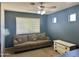 Cozy living room with a couch, dresser, fan and neutral colors for a comfortable atmosphere at 491 E Jeanne Ln, San Tan Valley, AZ 85140