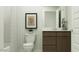 A well-lit bathroom with a modern vanity, elegant fixtures, and a framed piece of botanical artwork at 5064 S 234Th Ave, Buckeye, AZ 85326
