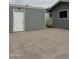 Spacious backyard featuring a shed with a white door and gravel at 5303 W Port Au Prince Ln, Glendale, AZ 85306