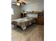 Bedroom with a wood-trimmed headboard, built-in cabinets, and drawers at 5303 W Port Au Prince Ln, Glendale, AZ 85306