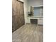 Bedroom with wooden sliding closet doors and a built-in vanity with a mirror at 5303 W Port Au Prince Ln, Glendale, AZ 85306