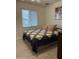 Cozy bedroom with a quilt patterned bedspread and natural light from the window at 5303 W Port Au Prince Ln, Glendale, AZ 85306