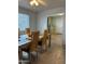 Bright dining room with a chandelier fan and a unique modern table at 5303 W Port Au Prince Ln, Glendale, AZ 85306