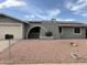 Charming home featuring a unique architectural front with decorative rock landscaping, solar panels, and mailbox at 5303 W Port Au Prince Ln, Glendale, AZ 85306