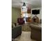 Open-concept living room showcasing multiple seating areas and seamless access to the kitchen at 5303 W Port Au Prince Ln, Glendale, AZ 85306