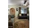 Comfortable living room area with couches, a ceiling fan, archway and area rug at 5303 W Port Au Prince Ln, Glendale, AZ 85306