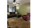 Comfortable living room with seating area, ceiling fan, window, and area rug at 5303 W Port Au Prince Ln, Glendale, AZ 85306