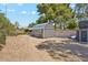 View of backyard with gravel, block fence, mature landscaping and large storage shed at 5402 E Cortez Dr, Scottsdale, AZ 85254