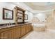 Luxurious bathroom features dual sinks, a marble countertop, and a large soaking tub for a spa-like experience at 5402 E Cortez Dr, Scottsdale, AZ 85254