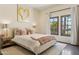 Inviting bedroom with neutral tones, accent pillows, and natural light from the window at 5402 E Cortez Dr, Scottsdale, AZ 85254