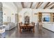 Open-concept dining and living areas with stone walls, exposed wood beams, and modern decor at 5402 E Cortez Dr, Scottsdale, AZ 85254