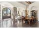 Spacious dining area connected to the living room with natural light, stone accents, and iron doors at 5402 E Cortez Dr, Scottsdale, AZ 85254