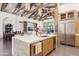 Bright, open kitchen with marble countertops, a kitchen island sink, modern appliances, and open layout to the living spaces at 5402 E Cortez Dr, Scottsdale, AZ 85254
