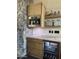Cozy kitchenette featuring a wine fridge, built-in coffee machine, wood cabinets, and marble countertops at 5402 E Cortez Dr, Scottsdale, AZ 85254