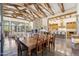 Open floor plan with a kitchen, dining, and living area, exposed beams, and stone accents make the space feel spacious at 5402 E Cortez Dr, Scottsdale, AZ 85254