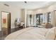 Bright main bedroom with a sitting area, vanity, and doors leading to the outside at 5402 E Cortez Dr, Scottsdale, AZ 85254
