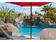 Spectacular rock waterfall flowing into sparkling blue pool, creating a peaceful backyard oasis at 5402 E Cortez Dr, Scottsdale, AZ 85254
