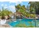 Stunning pool area showcasing a rock waterfall surrounded by tropical landscaping and serene blue water at 5402 E Cortez Dr, Scottsdale, AZ 85254