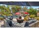 Inviting poolside patio with comfortable seating, perfect for lounging by the waterfall pool and mature landscaping at 5402 E Cortez Dr, Scottsdale, AZ 85254