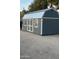 Exterior view of gray shed with white trim, double doors, windows, and string lights at 5402 E Cortez Dr, Scottsdale, AZ 85254