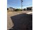 Backyard featuring a mix of gravel and grassy areas, with an open sky view at 5517 E Boise St, Mesa, AZ 85205