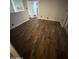 Versatile room with wood-look flooring and modern lighting fixtures at 5517 E Boise St, Mesa, AZ 85205