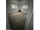 Neutral bedroom with carpet, a ceiling fan, and two windows allowing for lots of natural light at 5517 E Boise St, Mesa, AZ 85205
