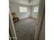 Bedroom featuring neutral carpet, two windows for natural light, and a side table at 5517 E Boise St, Mesa, AZ 85205