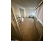 Bonus room with wood look flooring, shelving and multiple windows for lots of natural light at 5517 E Boise St, Mesa, AZ 85205