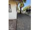 Side yard shows a palm tree near the house and a white car parked in the distance at 5517 E Boise St, Mesa, AZ 85205