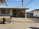 Inviting home exterior with covered parking, xeriscaping, and charming architectural details at 5517 E Boise St, Mesa, AZ 85205
