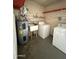 Laundry room with a utility sink and a washer and dryer at 5517 E Boise St, Mesa, AZ 85205