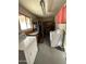 Laundry room area with utility sink, workbench, shelving, and a washer and dryer at 5517 E Boise St, Mesa, AZ 85205