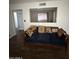 Spacious living room with plush seating, ample natural light, and wood-look floors at 5517 E Boise St, Mesa, AZ 85205