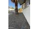 Narrow side yard next to the home, landscaped with gravel at 5517 E Boise St, Mesa, AZ 85205