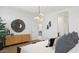 Modern bedroom with a decorative mirror, pendant lighting, and minimalist decor throughout at 5549 E Mearn Rd, San Tan Valley, AZ 85140