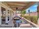 Covered back patio with a ceiling fan, seating area, and view of the landscaped backyard at 560 W Duke Dr, Tempe, AZ 85283