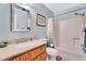 Bathroom featuring a large vanity, tub, and shower combo at 560 W Duke Dr, Tempe, AZ 85283