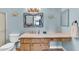 Bathroom features light blue walls, wood vanity with ample counter space, and decorative turtle accents at 560 W Duke Dr, Tempe, AZ 85283