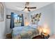 Bedroom with a ceiling fan, tiled floors, and fish decorations on the headboard at 560 W Duke Dr, Tempe, AZ 85283
