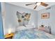 Bedroom with a ceiling fan, tiled floors, and fish decorations on the headboard at 560 W Duke Dr, Tempe, AZ 85283