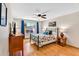 Bright bedroom with a queen bed, wood flooring, and a window with blue curtains at 560 W Duke Dr, Tempe, AZ 85283
