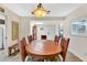 Charming dining room with tile flooring, a round wooden table, and views of the entryway and kitchen at 560 W Duke Dr, Tempe, AZ 85283