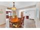Cozy dining area with a wooden table, floral chairs, and views of the kitchen and front door at 560 W Duke Dr, Tempe, AZ 85283