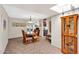 Bright dining area with tile flooring, a skylight, and views into the living room at 560 W Duke Dr, Tempe, AZ 85283