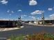 Peaceful street lined with well-kept homes, vibrant flowers, and mature trees at 5735 E Mcdowell Rd # 63, Mesa, AZ 85215