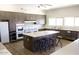 Spacious kitchen featuring a large island with seating, stainless steel appliances, and ample counter space at 5735 E Mcdowell Rd # 63, Mesa, AZ 85215