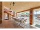 Large covered patio featuring tiled floors, brick columns, and an outdoor dining area with community views at 5735 E Mcdowell Rd # 63, Mesa, AZ 85215